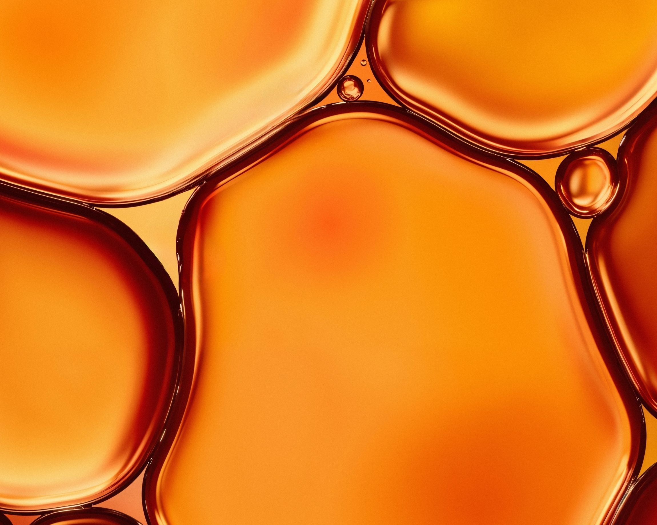 Close-up of amber-colored liquid with bubbles
